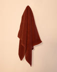 Cotton bathmat hanging on cream wall