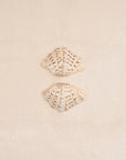 Two clam shells on a Crema textured cotton bath mat 