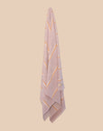 Lilac turkish towel by kobn hanging with marigold yellow stripes. 