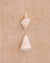 Chunky textured cotton bathmat in sand colour with two shells on top. 