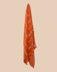 Tamarillo turkish towel hanging ith stripes in yellow and brown.