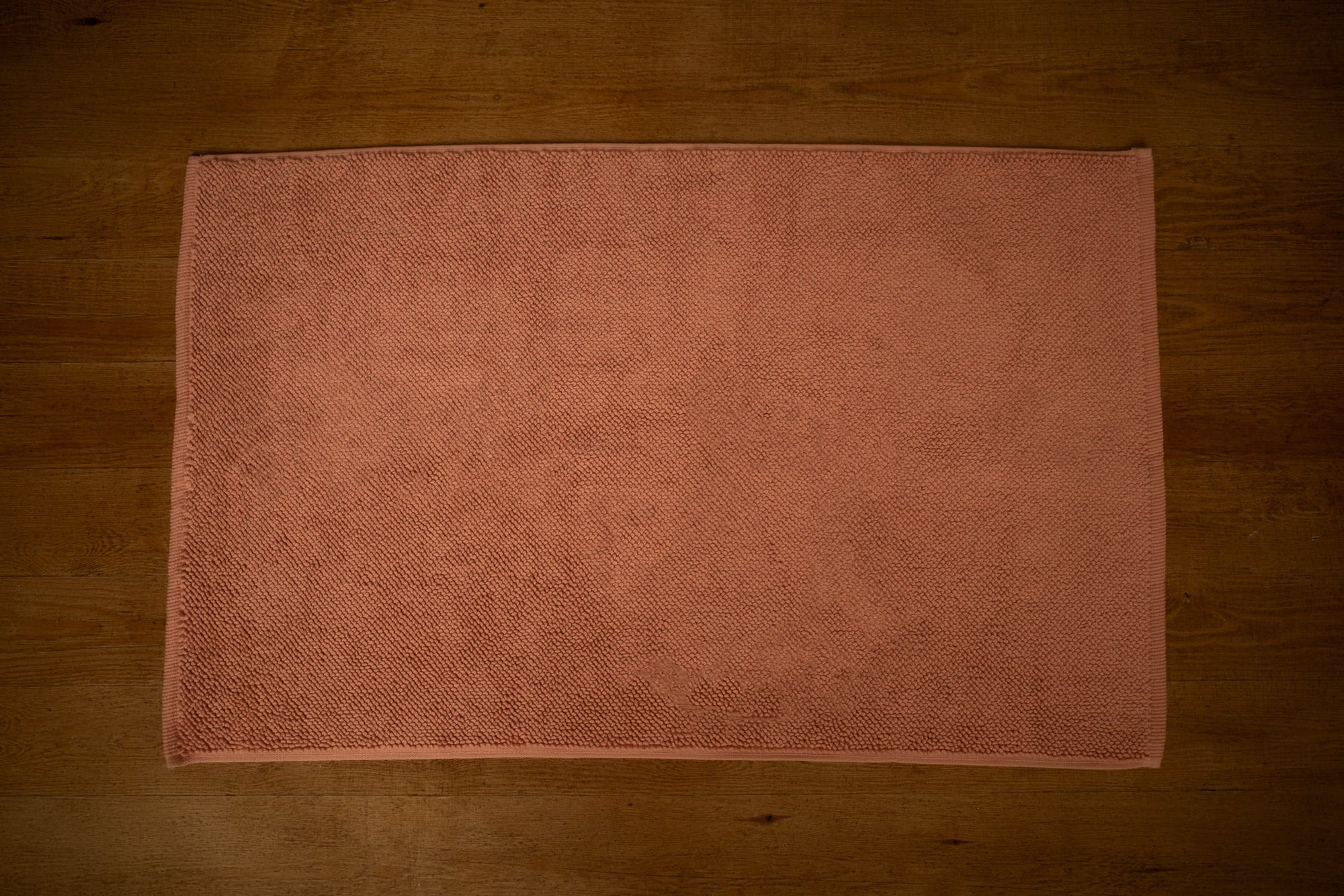 Clay bathmat laid flat on floorboards