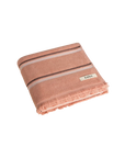 Folded Clay towel with black and cream stripes, raw edge fringing. Kobn logo. 