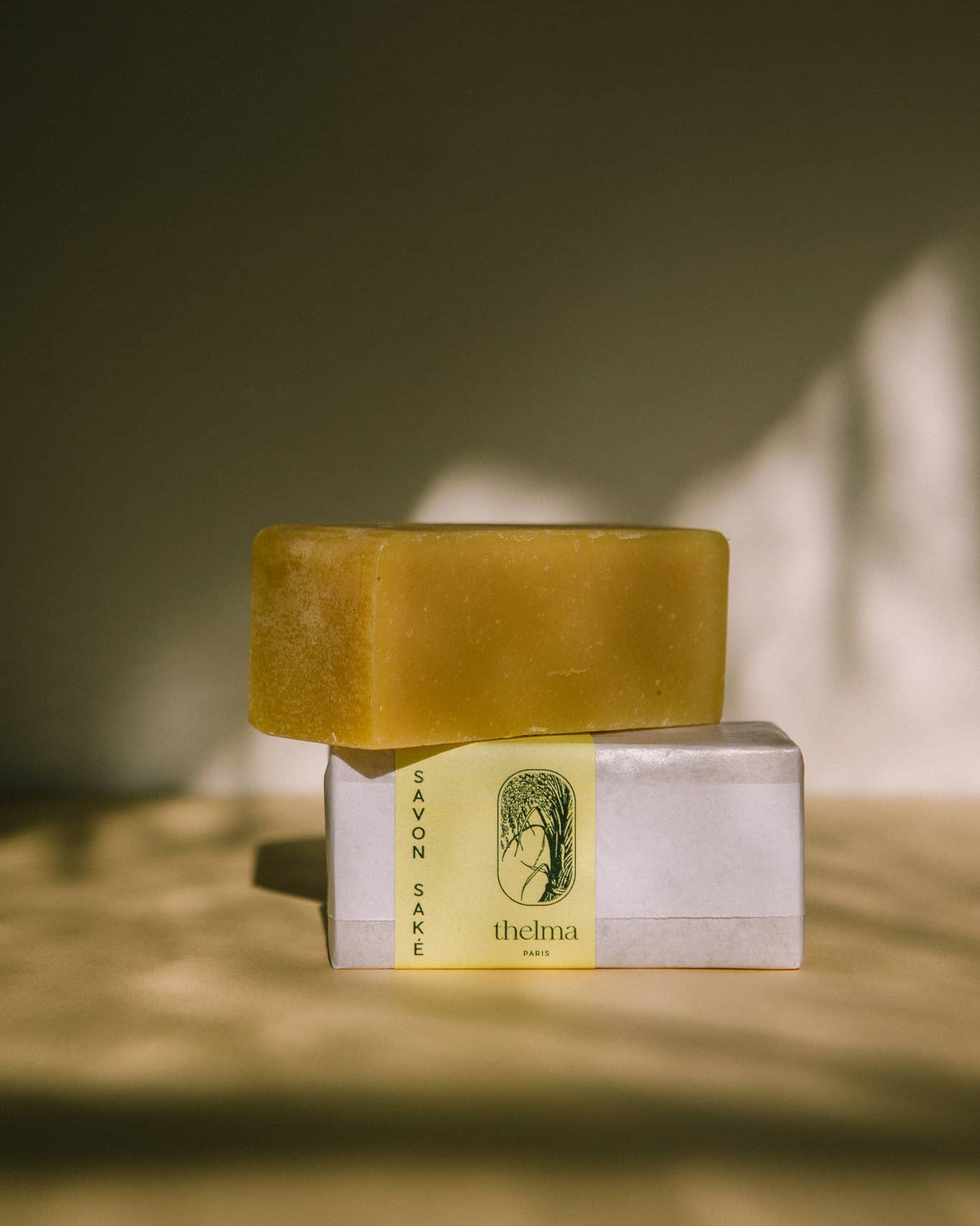 Bar of soap with packaging on a neutral background