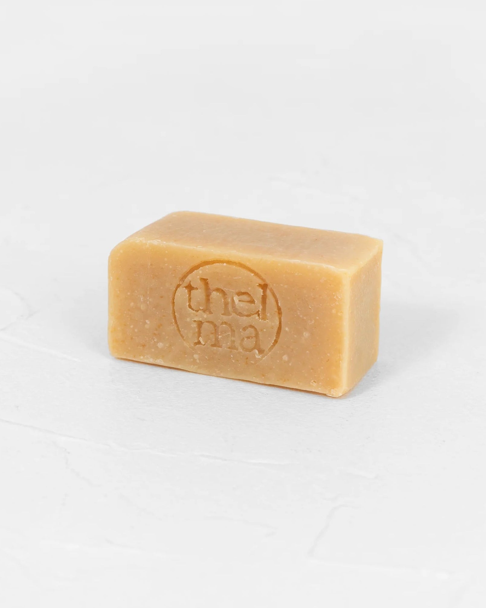 Bar of soap with thelma branding on a white background